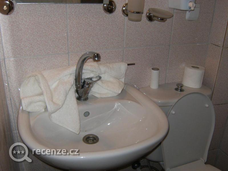 držák s ručníkem hozený na umyvadle,žádná polička