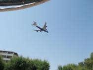 Foto z pláže - přistává letadlo