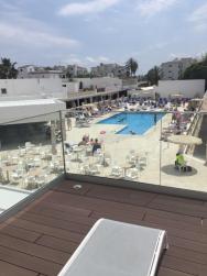výhled ze sluneční terasy na bazén a bar